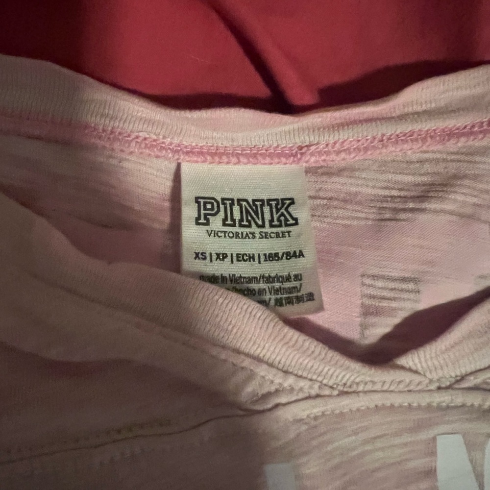 Mid length sleeves. The color is washed out pink.